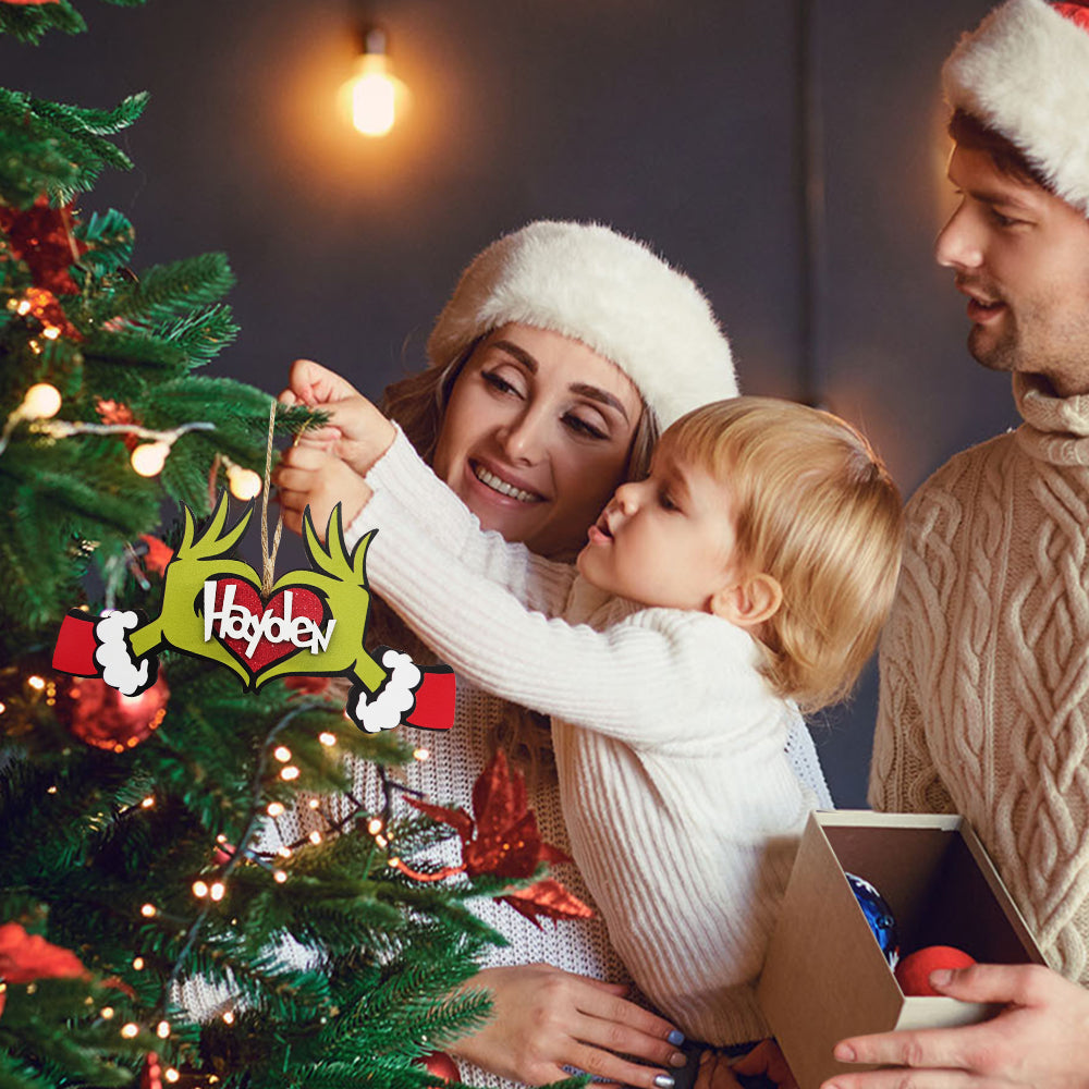 Family decorating Christmas tree with Personalized Name Ornament, wood material, unique Christmas gift.